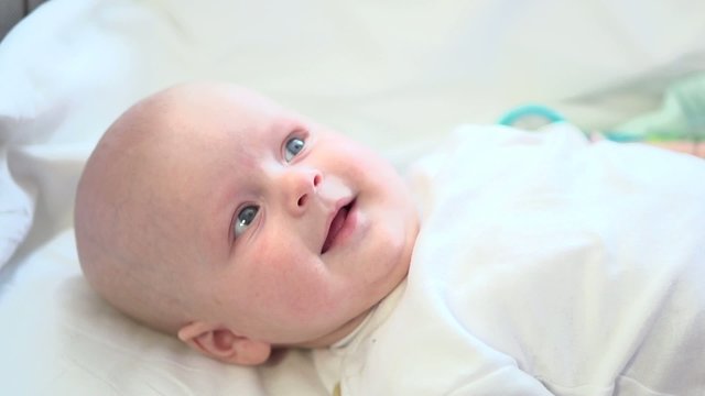 Healthy adorable newborn baby smiling. Slow motion 240 fps