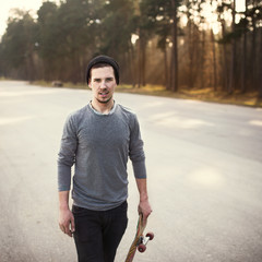 fashionable guy with skateboard