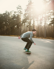 hipster boy skateboarder riding a skateboard in the park