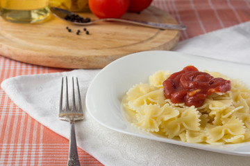 Farfalle with tomato sauce on white dish
