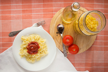 Farfalle with tomato sauce on white dish