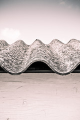 Fototapeta na wymiar Dangerous asbestos roof - Toned image
