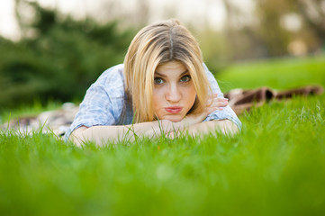portrait of a beautiful woman sitting in grass