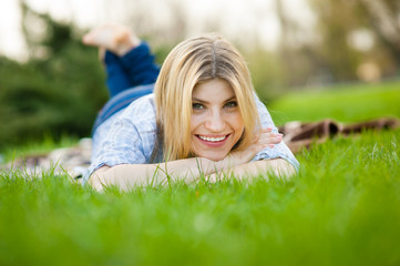 portrait of a beautiful woman sitting in grass