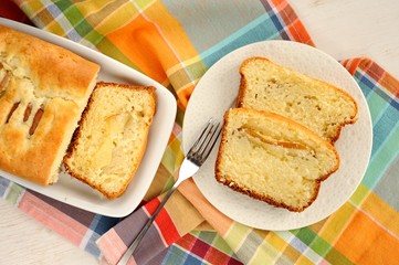 Mascarpone cake slice, long fork on white bright background top