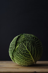 Fototapeta premium Green Cabbage on Wood Plank Table