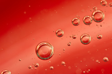 Air bubbles in a red liquid