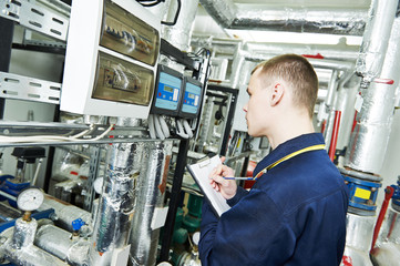 Fototapeta premium heating engineer repairman in boiler room