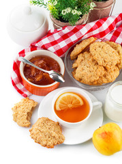 Breakfast with tea and fresh cookies. Isolated on white
