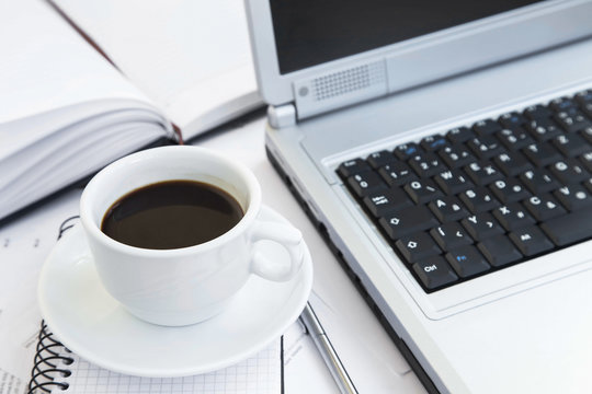 Coffee Cup at Office over Financial Papers,Computer and Agenda.C