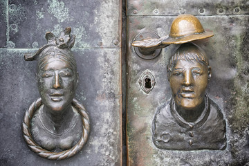 Door with head of woman and man