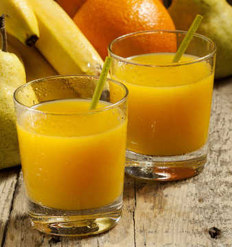 multifruit citrus juice from oranges, lemons, bananas in a glass