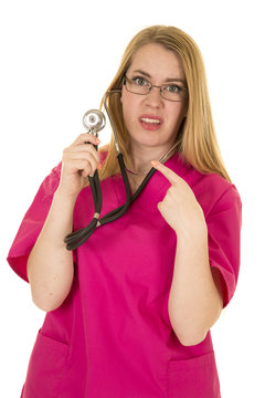 Nurse In Pink Outfit With Stethoscope Point