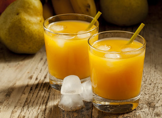 multifruit citrus juice from oranges, lemons, bananas in a glass