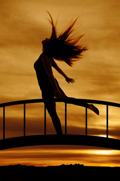 silhouette of woman hair flying leg back