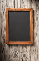 old blackboard on aged wooden wall