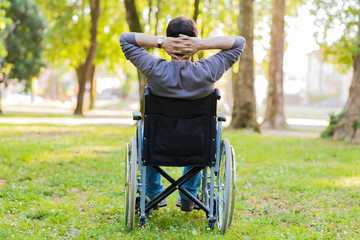 Man on a wheelchair relaxing in a park