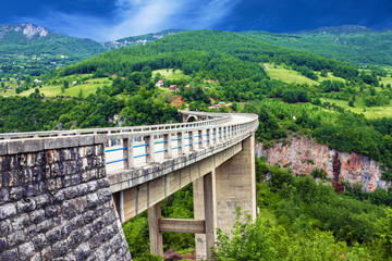 Fototapeta na wymiar Bridge construction. Arc bridge in the mountains, North of Monte