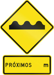 Warning road sign in Chile: Uneven road ahead. Proximos means distance