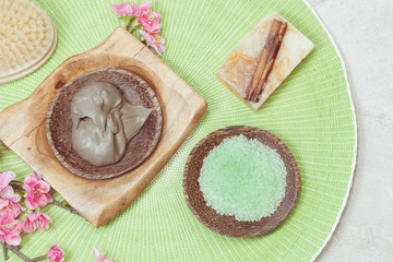 Spa setting with natural cinnamon soap,mud,green tea salt