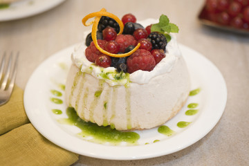 Pavlova with forest fruits and basil coulis