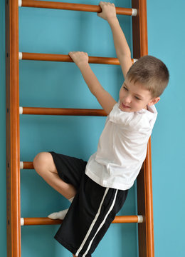boy looking down from the ladder