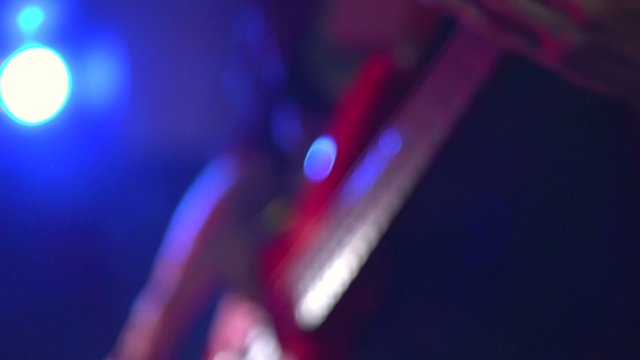 Man playing a guitar at a rock concert