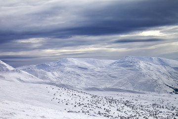 Winter mountains and gray sky