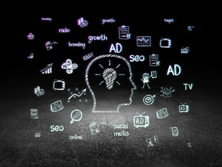 Advertising concept: Head With Lightbulb in grunge dark room