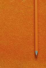 orange pencil on orange texture background