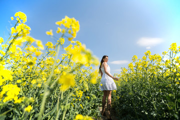 Fototapeta premium Young woman in the spring field
