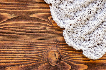 Grey knitted napkin on dark wooden table