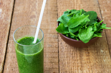 Fresh green smoothie with spinach on wooden backround