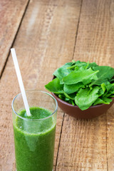 Healthy green smoothie with spinach on wooden backround