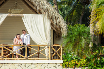 Young loving couple on tropical sea background - wedding at the