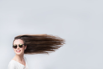 Cheerful woman with hair in the wind