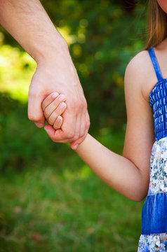 father holding  daughter hand