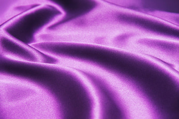 Fototapeta na wymiar Closeup of rippled purple silk fabric