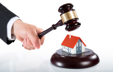 gavel on house - auction of real estate