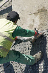 street worker repairing sidewalks and pipelines in the city