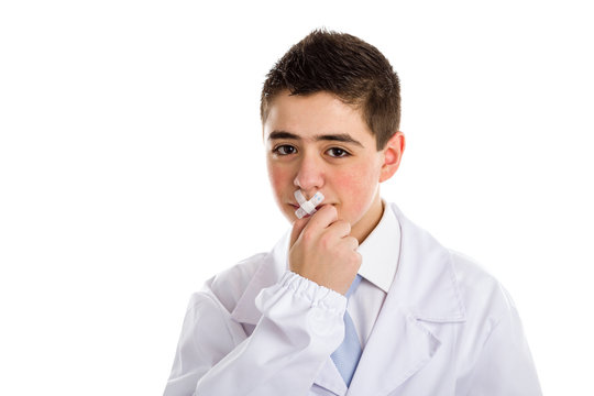 Band aids close the mouth of a boy doctor