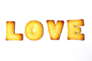 Love text made of cookies isolated on white background