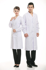 Staff wear coats in front of white background