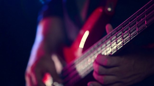 Man playing a guitar at a rock concert