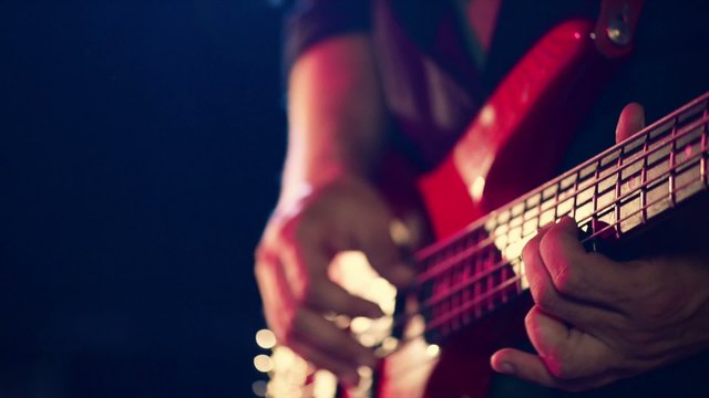 Man playing a guitar at a rock concert