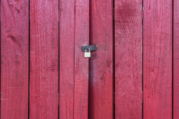 The red wooden door with lock