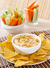 Healthy homemade hummus with vegetables, olive oil and pita chip