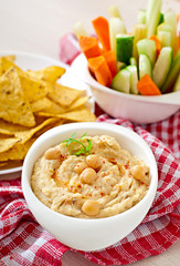 Healthy homemade hummus with vegetables, olive oil and pita chip