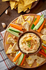 Healthy homemade hummus with vegetables, olive oil and pita chip