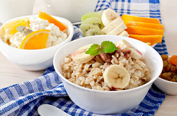 Healthy breakfast - oatmeal, cottage cheese, milk and fruit